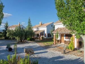 a large house with a yard with trees at Bungalow with Pool in Pozo Alcón in Cuenca