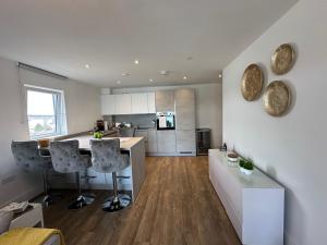 a kitchen with a table and chairs in a room at Waterfront luxury apartment in Southampton