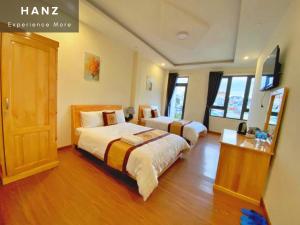 a bedroom with two beds and a wooden floor at S79 Hoa Dang Dalat in Da Lat