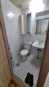 a bathroom with a toilet and a sink at Huestay Gumdan in Samgong