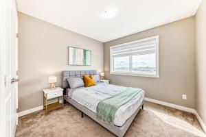 a bedroom with a bed and a window at Cozyhub Vacation Rental Calgary-3Bedroom with AC in Calgary