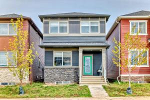 a house with a green door on a street at Cozyhub Vacation Rental Calgary-3Bedroom with AC in Calgary