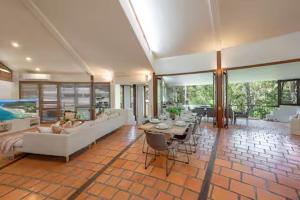 a living room with a couch and a table at Little Cove 4BR Home, Pool, Pool table, Sleeps 16 in Noosa Heads