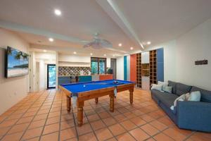 a living room with a pool table and a couch at Little Cove 4BR Home, Pool, Pool table, Sleeps 16 in Noosa Heads