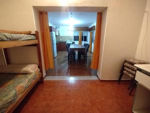 a room with bunk beds and a dining room at OKIN 1 Teresita in Santa Teresita