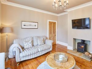 a living room with a couch and a fireplace at Oakwood in Sleights