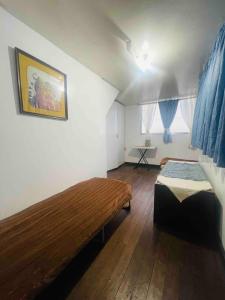 a bedroom with a bed and a wooden floor at Lowest Price Room In Chinatown Davao with WiFi Room 6 in Davao City