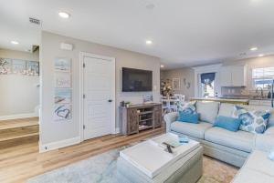 a living room with a couch and a table at Front row Seat at 'The Sandy Rose' in Biloxi