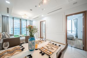 a dining room with a table and a couch at The Landmark Luxury - Apartment in Ho Chi Minh City