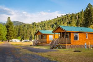 a large wooden cabin with a green roof at Yosemite Lakes Cabin 37 in Harden Flat