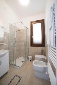 a bathroom with a shower and a toilet and a sink at Raggio Di Sale in Trapani