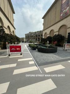 an empty street in front of a large building at The Oxford Street Stays in Zirakpur +10 photos