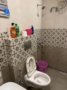 a small bathroom with a toilet and a sink at The Oxford Street Stays in Zirakpur