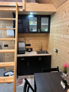 a small kitchen with a sink and a table at La - Mai Glamping in Žetale