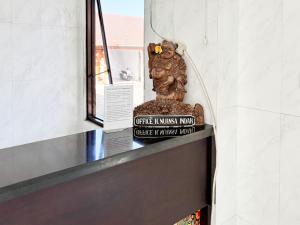a statue of a monkey sitting on top of a counter at RedDoorz at Hotel Nuansa Indah Denpasar in Denpasar +48 photos