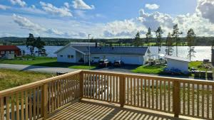 a view from the deck of a house on the water at Modern Lake House With Spa At Lake Barken in Sörbo