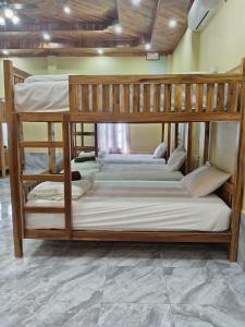 a couple of bunk beds in a room at Sunset Backpackers Hostel in Nongkhiaw