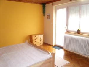 A bed or beds in a room at Viola Vendégház