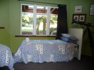 a bedroom with a bed and a window at Lovely rural 3 bedroom home near the Kahurangi NP 