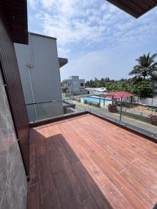 a deck with a view of a swimming pool at Brownie beach house in Covelong