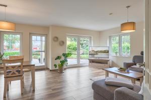 a living room with a tv and a table at Villa Kanalblick, Schiffsdeck in Oldenbüttel