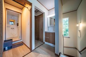 a bathroom with a walk in shower and a sink at Niseko Mt Village in Niseko
