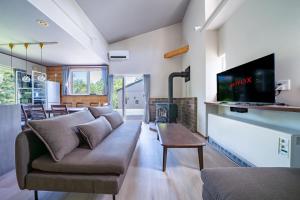 a living room with a couch and a fireplace at Niseko Mt Village in Niseko