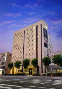 a large building with a sign on the side of it at Hotel The Designers Kondae in Seoul