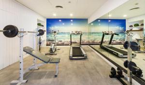 a gym with several tread machines in a room at Hoposa Daina- Adults Only in Port de Pollensa