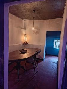 a table and chairs in a room with a ceiling at Adisham village agro garden villa in Haputale