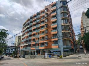 a large apartment building on a city street at 2F-14 City Center Cozy Condo at Megatower 4 in Baguio
