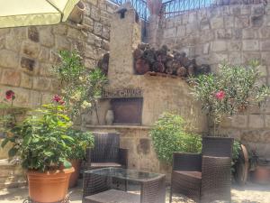 a patio with a table and chairs and plants at Erenbey Cave Hotel in Göreme