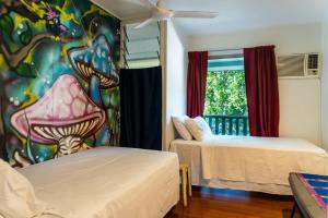 Una habitación con dos camas y un cuadro en la pared. en Urban Jungle Townhouse - Tropical Living, en Edge Hill