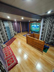 a living room with a large painting on the wall at The District Green in Kalpa