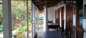 a room with sliding glass doors and a table and chairs at Tree Cool Resort in Ella