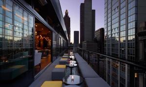 a restaurant with a view of the city at Royalton Park Avenue in New York