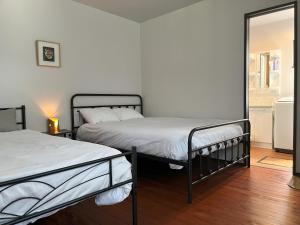 two beds in a room with a mirror at ホシヤドリ hoshiyadori in Setouchi