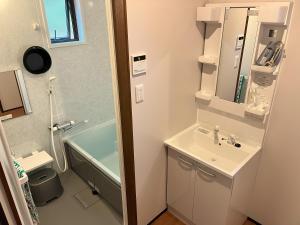 a bathroom with a sink and a bath tub at ホシヤドリ hoshiyadori in Setouchi +18 photos
