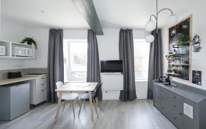 a kitchen with a table and a dining room at Breuil Station, studio tout confort in La Mure