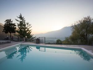 a swimming pool with a view of the mountains at Lakeside Mansion with Pool in Artogne