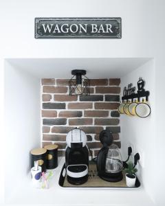 a kitchen counter with a coffee maker on a shelf at Breuil Station, studio tout confort in La Mure