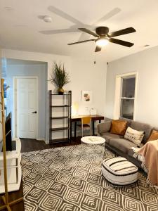 a living room with a couch and a ceiling fan at Prime Location Retreat 4 Bedrooms w Parking in Chicago