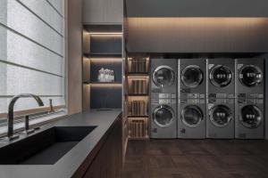 a kitchen with four washing machines and a sink at Atour Hotel, Wending Road, Xujiahui Center, Shanghai in Shanghai