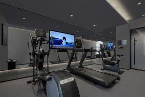 a gym with two exercise bikes and a flat screen tv at Atour Hotel, Wending Road, Xujiahui Center, Shanghai in Shanghai +132 photos