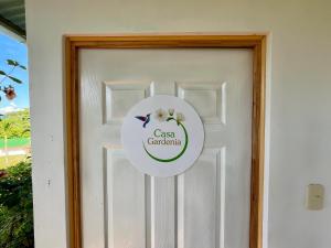 a door with a sign that reads cason gardenaria at Jardín Secreto in San Martín