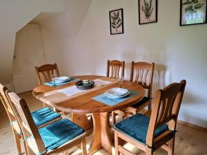 a wooden dining room table with four chairs and a table and chairsuggest at Ferienwohnung Öhlerhansl in Puchberg am Schneeberg +12 photos