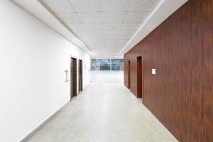an empty hallway in an office building with wooden walls at Collection O Vrindavan Yojna Lucknow Formerly Khushboo Palace in Nilmatha