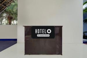 a sign for a hotel on the side of a wall at Super Hotel O Auroville Bird Sanctuary Chennai Formerly Vanam Resort in Puducherry
