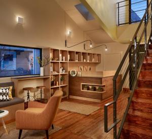 a living room with a staircase and a chair at Heywood Hotel in Austin
