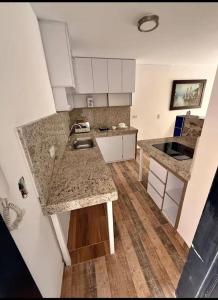 a kitchen with a sink and a counter top at Aparta estudios enceguida Hotel intercontinental in Cali